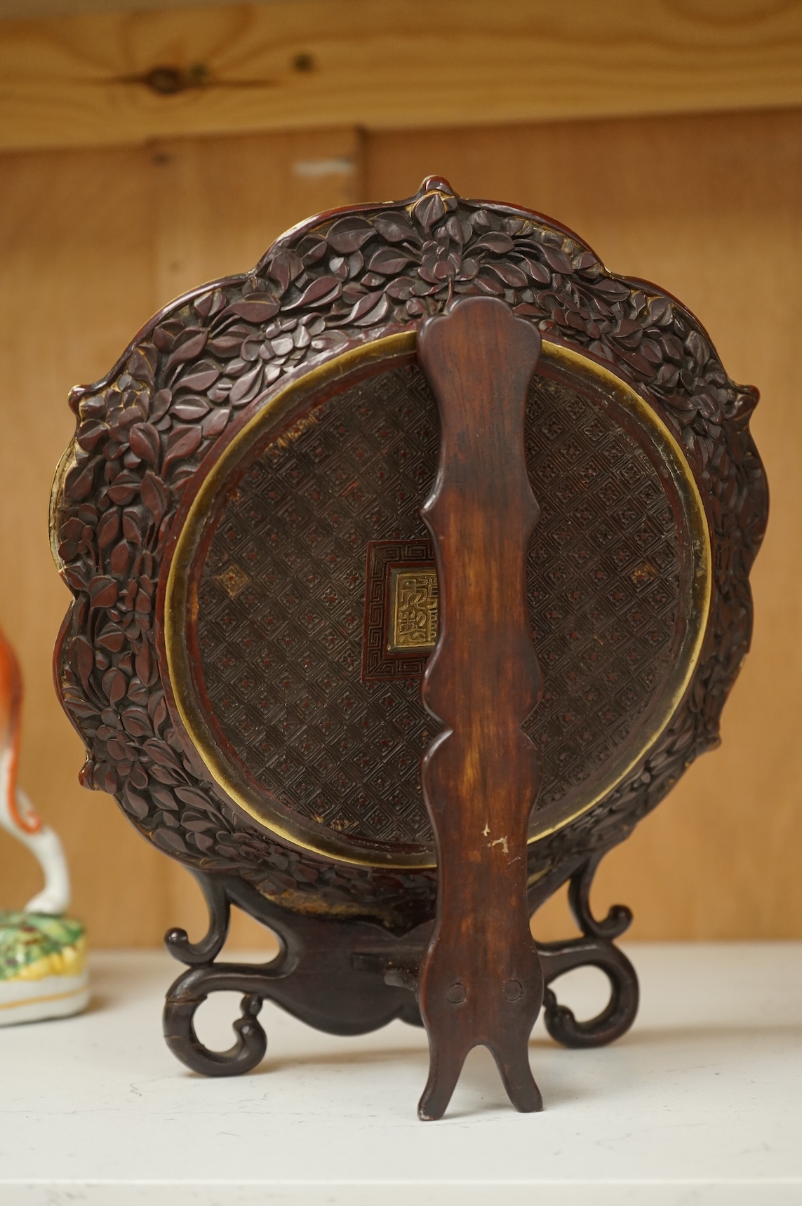 A Chinese lacquer foliate-shaped dish on stand, 18cm in diameter